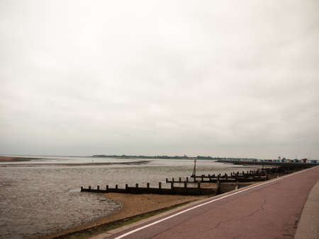 seaside scene overcast mudflats walkpath trail gryones; England; UKの写真素材