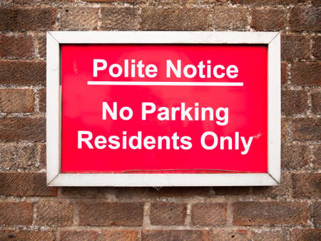 close up of red placard sign outside houses no parking residents only; England; UKの写真素材