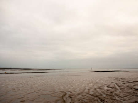 seafront mud scene of empty river overcast dayの写真素材