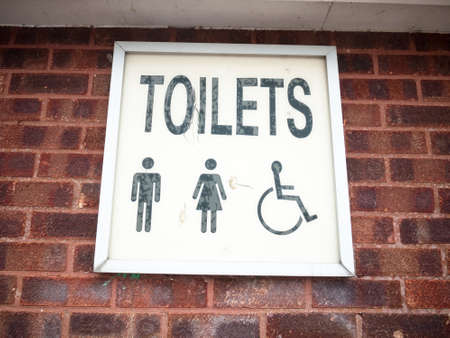 old retro lettering sign on wall toilets male and female and disabled; England; UK