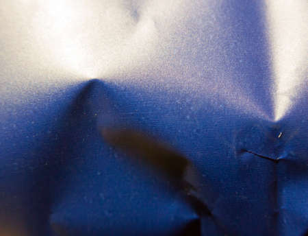 close up texture of blue metal crisp packet; England; UKの写真素材