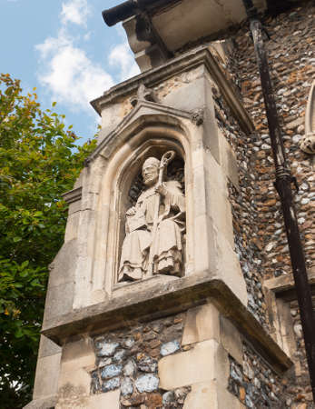statue of priest on the outside of english christian church made of stone;Essex; England; UKの写真素材