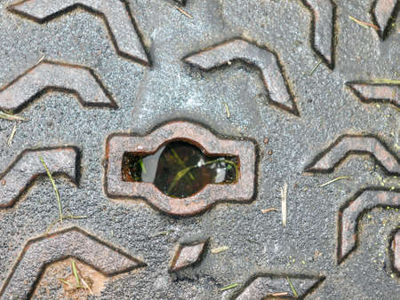 metal grate hole texture on the ground sewer top; England; UKの写真素材