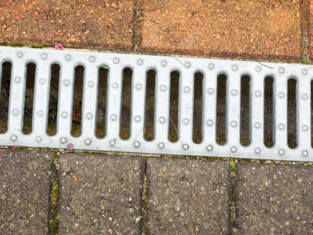 close up of metal grate on side of floor pavement; England; UK