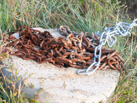 a rusty metal chain on the floor outside; England; Essex