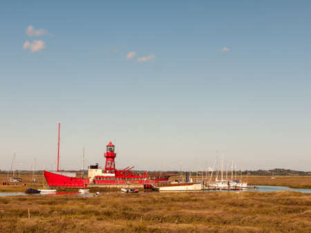 red life boat moored in tollesbury maldon estuary blue sky