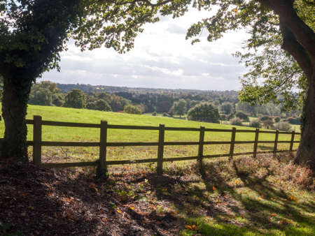 country side open rolling fields below with wooden fence up front; Essex; England; UKの写真素材