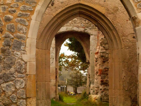 zoom in through stone arch ways of abandoned burnt down church; essex; england; ukの写真素材