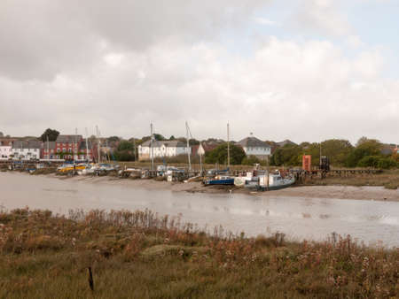 row of moored private boats in estuary autumn day; essex; england; uk