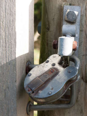 locked metal padlock on gate outside country closed; essex; england; ukの写真素材