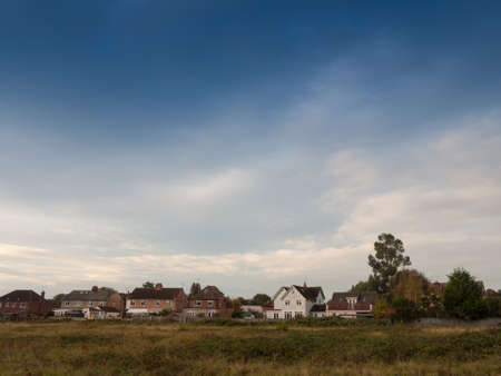 row of country houses with blue sky above horizonのeditorial素材