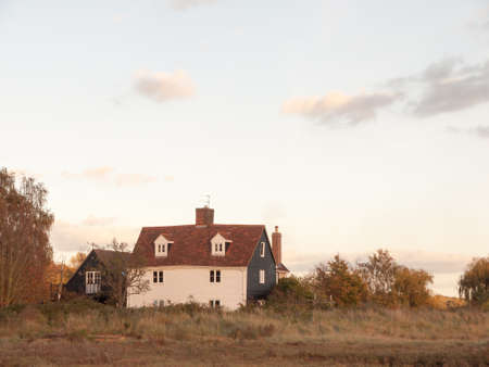 old white country farm house cottage in field; essex; england; ukの写真素材