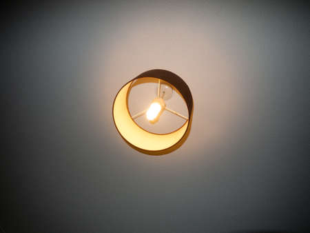 Bedroom ceiling light turned on electricity white bright; essex; england; uk