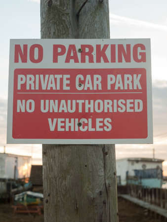 No parking private car park no authorized vehicles sign on post close up; west Mersea, Essex, England, UKの写真素材