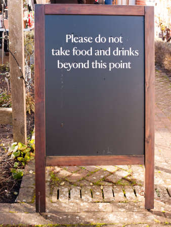 outside area restriction sign cafe - please do not take food and drinks beyond this point black and wood chalkboard; essex; england; ukの写真素材