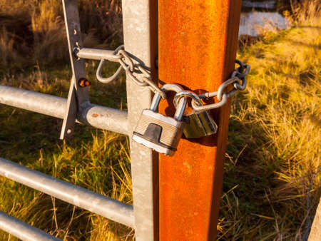 close up of metal padlock on gate and rusty fence; essex; england; ukの写真素材