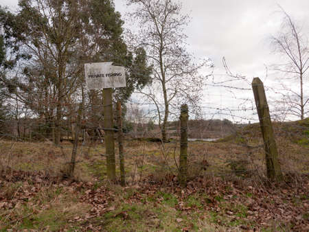 red breasted english robin resting on wooden fence post ahead country walk trail trek; essex; england; ukの写真素材