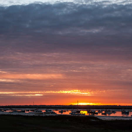 coastal boats beach sun set scene special nature background sky; essex; england; ukの写真素材