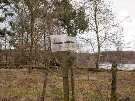 red breasted english robin resting on wooden fence post ahead country walk trail trek; essex; england; ukの写真素材