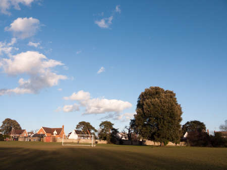 open grass plain with goal posts park spring blue cloudy sky; essex; england; ukの写真素材