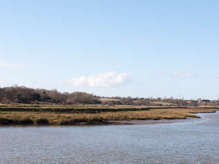 view of river stream in spring with horizon empty country; essex; england; uk