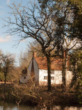 willy lotts cottage spring from across the lake on side river stour constable country close up;...