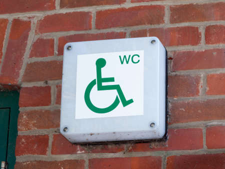 disabled wc toilet water closet sign outside on brick wall close up; essex; england; ukの写真素材
