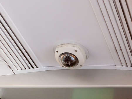close up of security cctv camera on train inside ceiling; essex; england; ukの写真素材