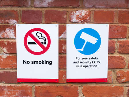 two signs at train station cctv no smoking; essex; england; ukの写真素材