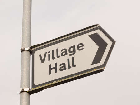 white and black village hall sign post direction street; essex; england; ukの写真素材