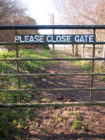 please close gate sign on metal closed gate outside country way ; essex; england; ukの写真素材
