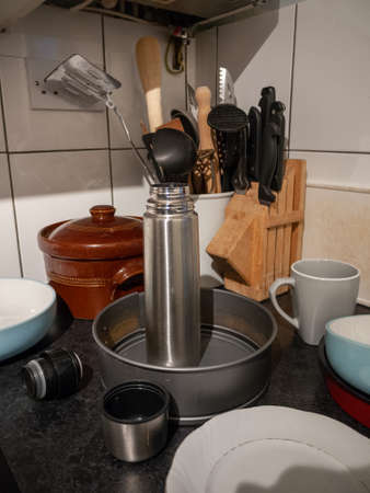 freshly washed kitchen utensils on side board in kitchen home; England; UK