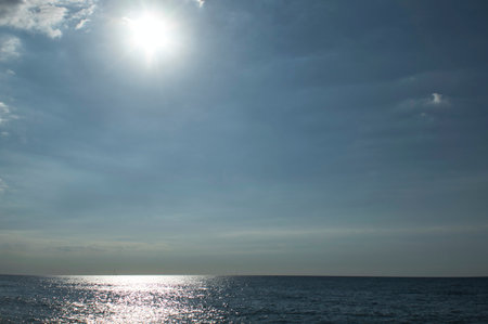 landscape with the horizon between the sky and the sea and the high sunの写真素材