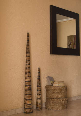 books in a living room on a wicker seatの写真素材