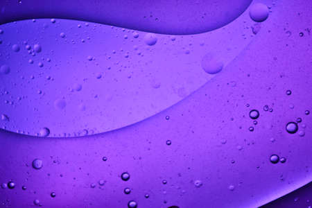 close-up view of a purple liquid background of moving bubblesの写真素材