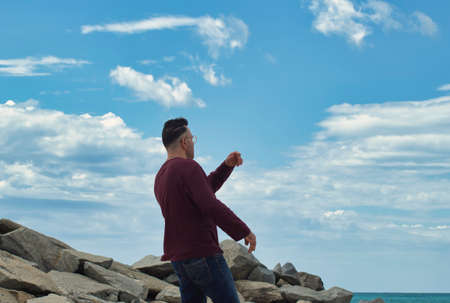 lonely man at the beach playing in the shoreの写真素材