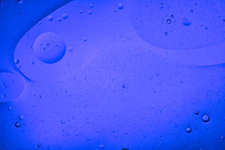 close-up view of a blue liquid background of moving bubblesの写真素材