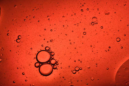 close-up view of an orange liquid background of moving bubblesの写真素材