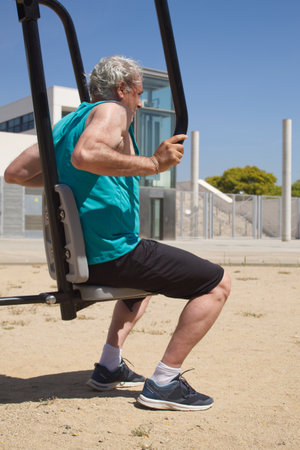 side view of a man training on the street with sports machine