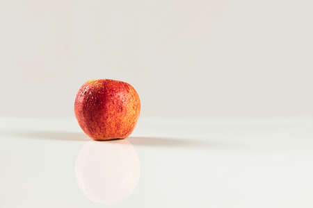 foreground of red apple with drops on white backgroundの写真素材