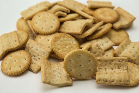 close-up of salty square and round shaped cookies on white backgroundの写真素材