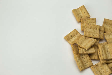 close-up of view from above of salty square shaped cookies on white background with copy spaceの写真素材