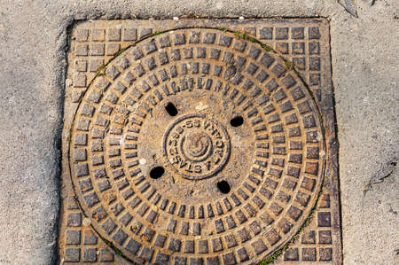 Rusty metal sewer manhole closed for a long time