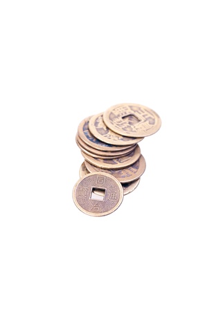 A stack of old chinese coins isolated on white backgroundの写真素材