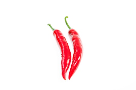 Two fresh red chilies close up on with backgroundの写真素材
