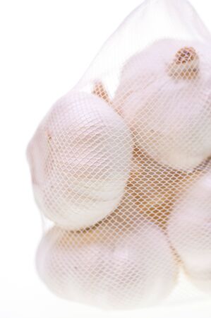 Bulbs of garlic in a bag fresh from the marketの写真素材