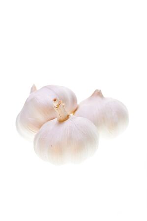 Three bulbs of garlic on a white backgroundの写真素材