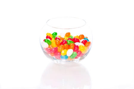Colourful jelly beans in a glass bowl isolated on white backgroundの写真素材