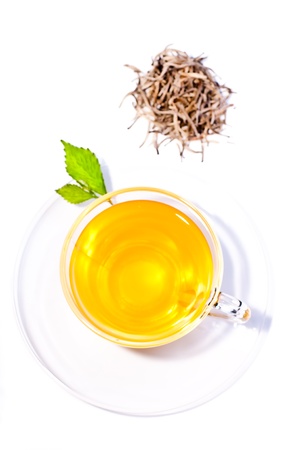 Siver tips tea top view over white background with fresh tea leaves and silver tips leavesの写真素材