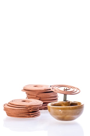 Mini incense coil burning with stack of coils at the backgroundの写真素材